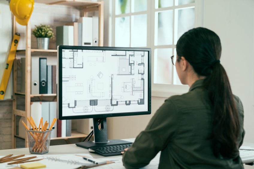 Woman sitting in front of her computer with good posture